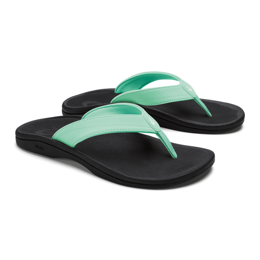 Pair of flip-flops with mint green straps and black footbeds.