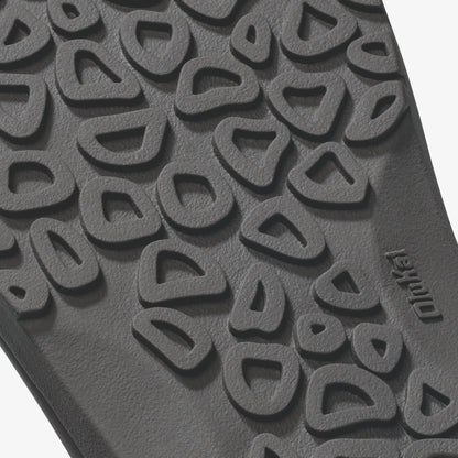 Gray rubber sole with textured tread pattern and curved geometric designs throughout.