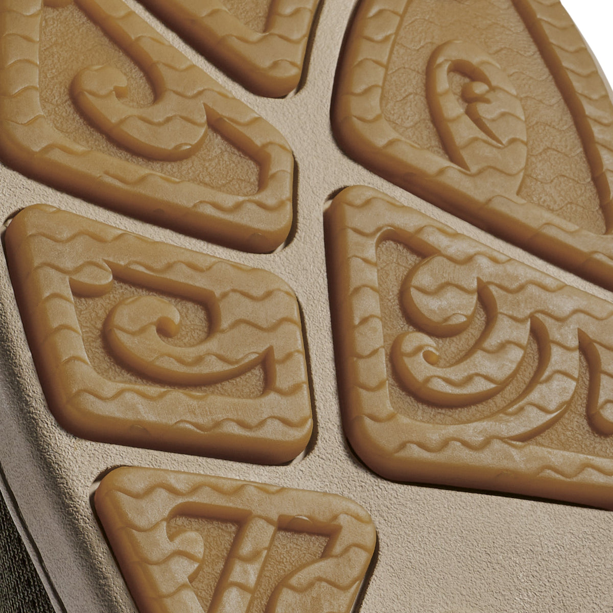 Tan rubber sole with carved tread pattern featuring decorative wavy lines and geometric designs.