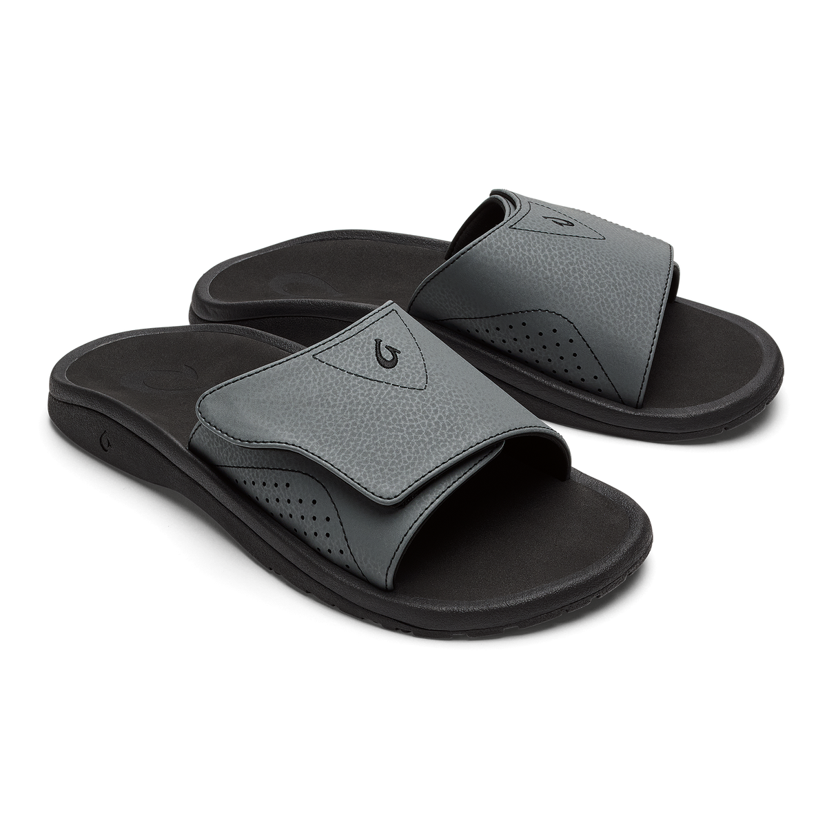 Pair of gray and black slide sandals with perforated details and black sole.