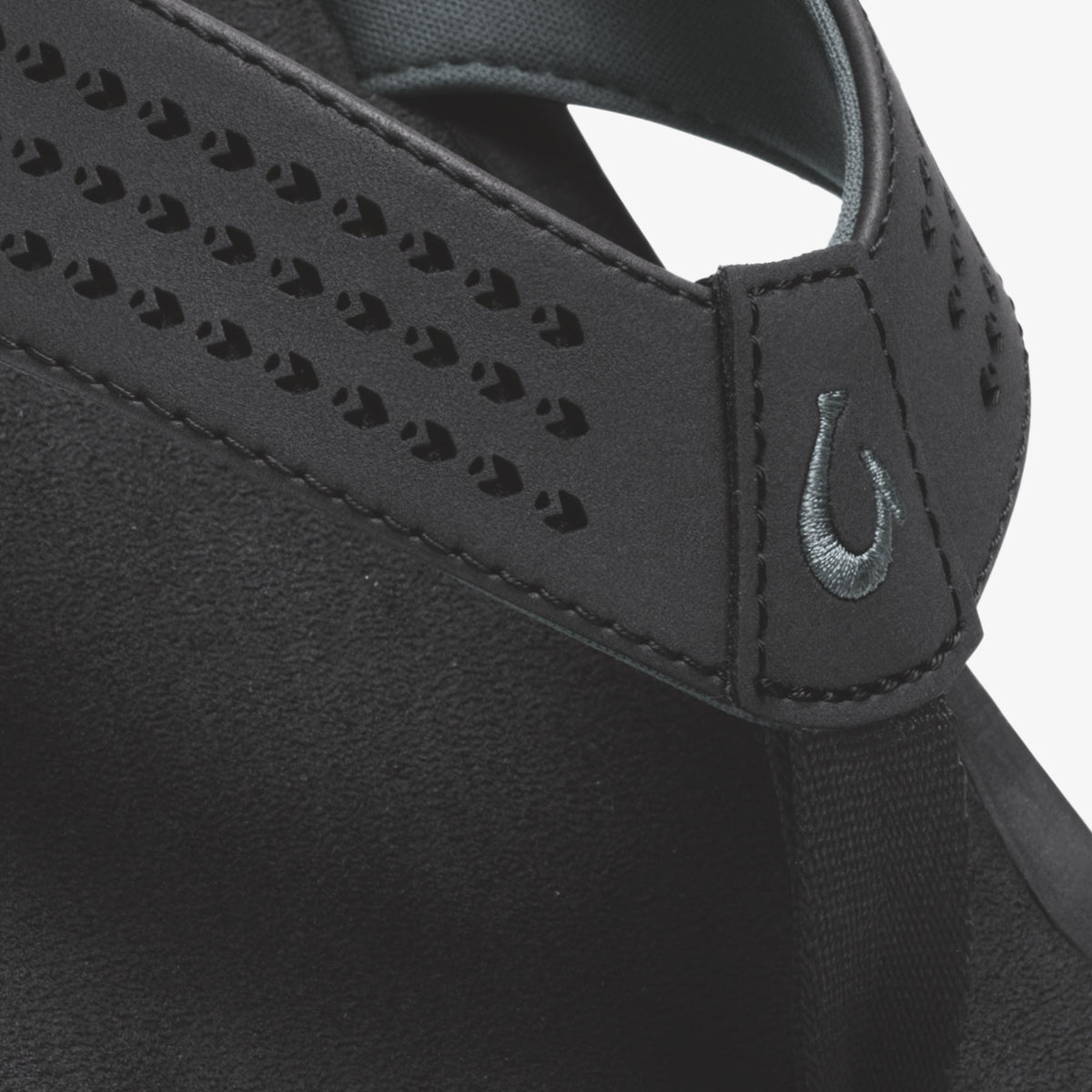 Black sports bra with perforated panel detailing, adjustable straps, and swoosh logo.