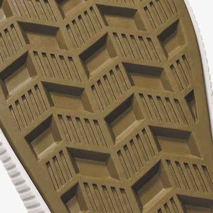 Tan and white sole with geometric tread pattern featuring rectangular shapes and linear grooves.
