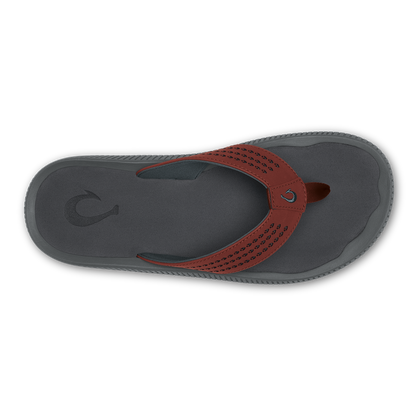 Gray and rust-red flip-flop sandal with perforated strap and textured sole, top view.