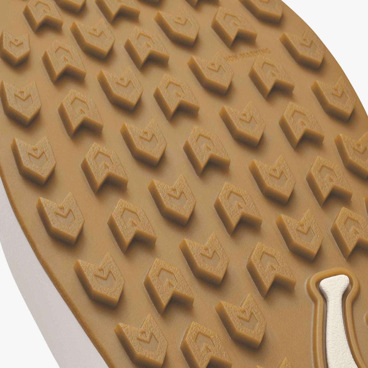 Tan rubber sole with geometric tread pattern and white heel accent.