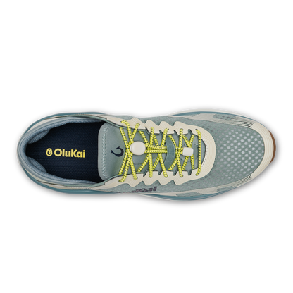 Seagreen and white sand athletic shoe with yellow laces, viewed from above, featuring OluKai branding.