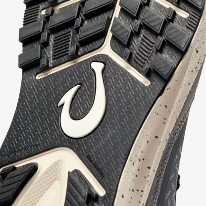 Black rubber sole with white hook logo, textured tread pattern, and grey speckled side panel.