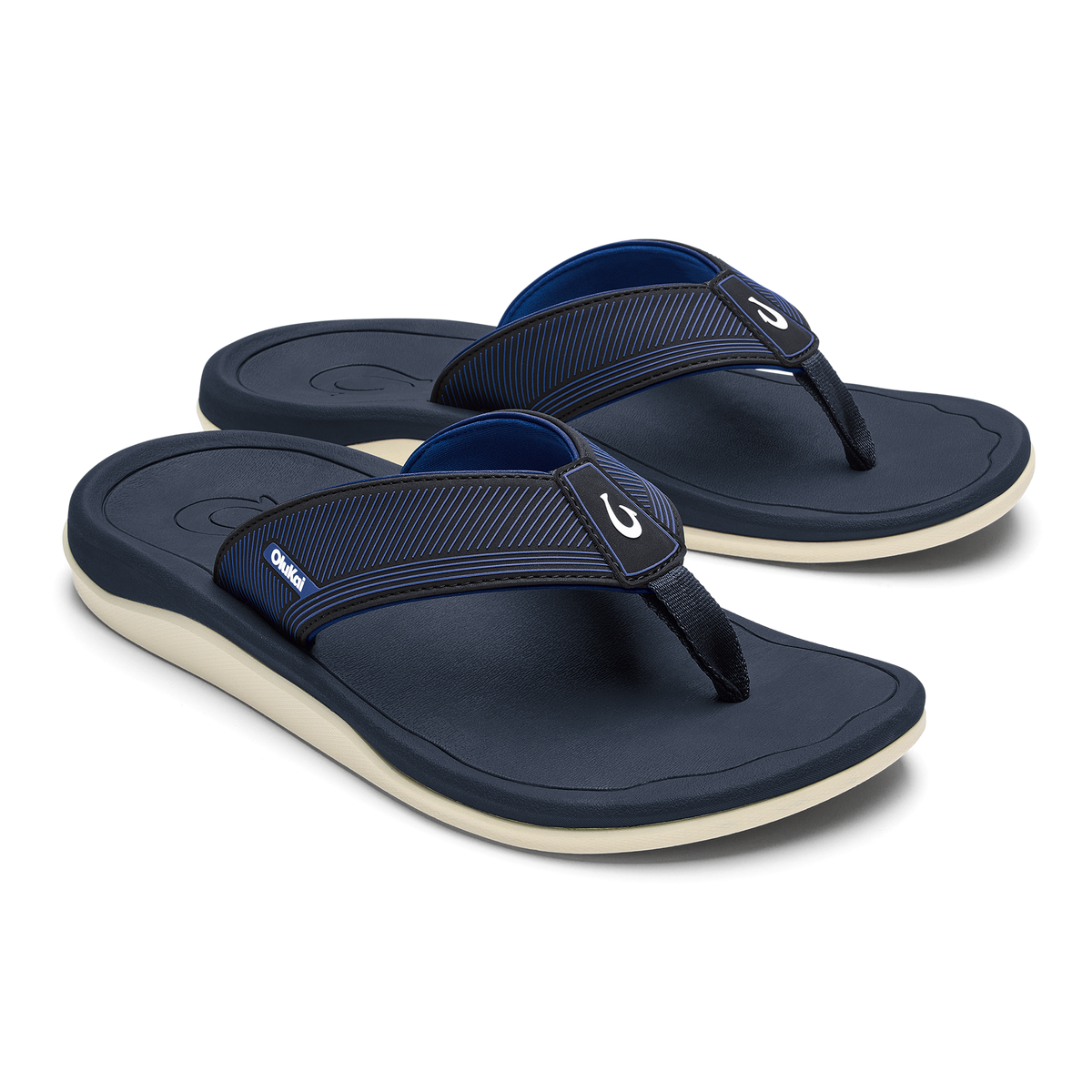 Pair of dark blue thong sandals with ribbed straps and cream-colored soles.