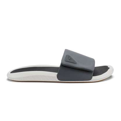 Gray and white slide sandal with padded upper and textured sole.