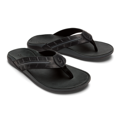 Pair of dark gray flip-flops with textured straps and circular toe post closures, shown from above.