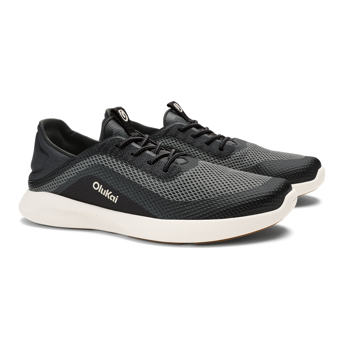 Black mesh athletic shoe with white sole and OluKai branding on the side.