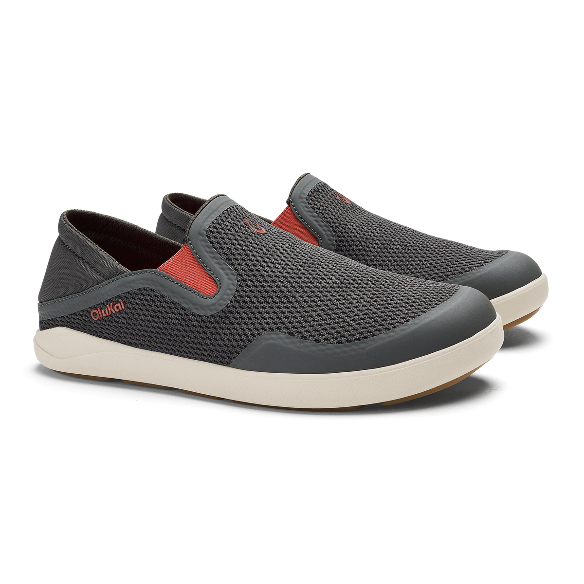 Gray slip-on sneaker with textured mesh upper, coral-red accent panel, and cream rubber sole.