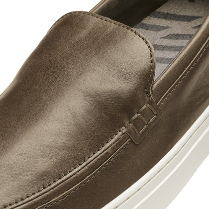 Walnut leather slip-on shoe with white sole and geometric patterned insole detail.