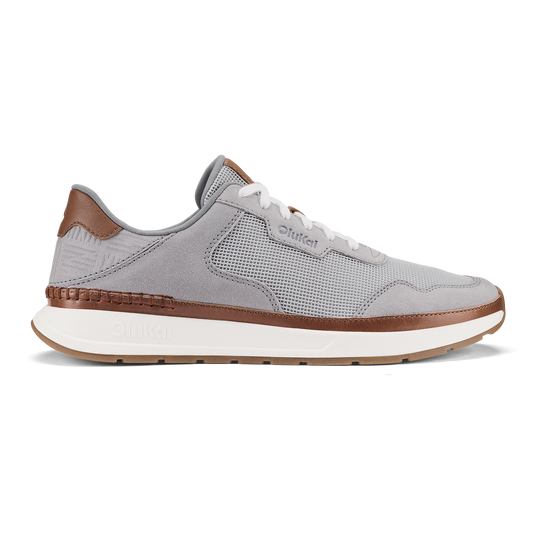 Light grey and brown sneaker with mesh upper, white laces, and cream-colored sole.