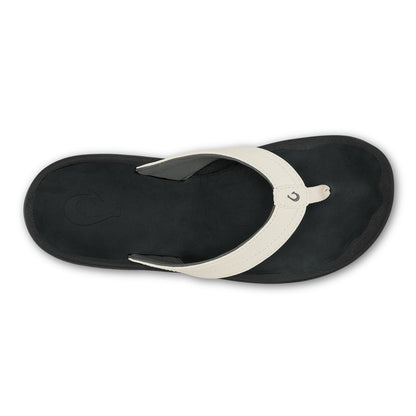 Black and white thong sandal with white strap across black sole, shown from above.