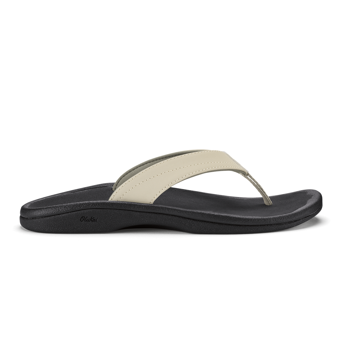 Ecru and black thong sandal with curved black sole and cushioned footbed.