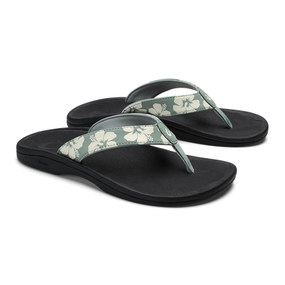 Pair of black thong sandals with silver pine and cream floral patterned straps.