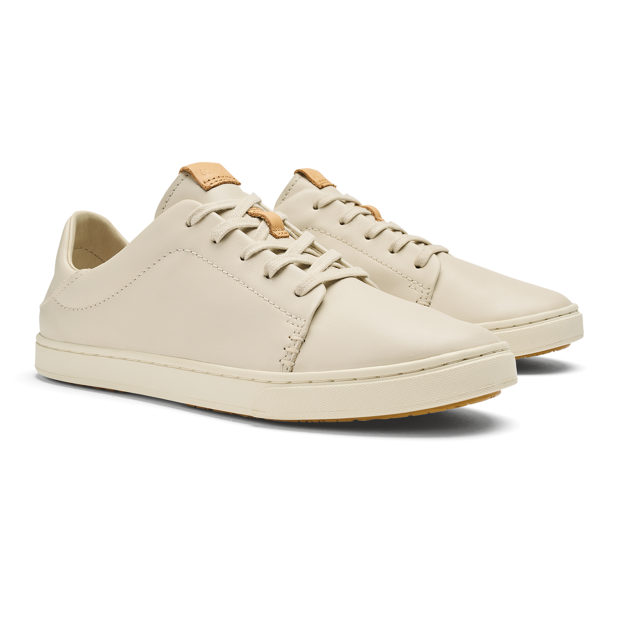 Cream leather lace-up sneaker with tan heel collar and gum rubber sole.