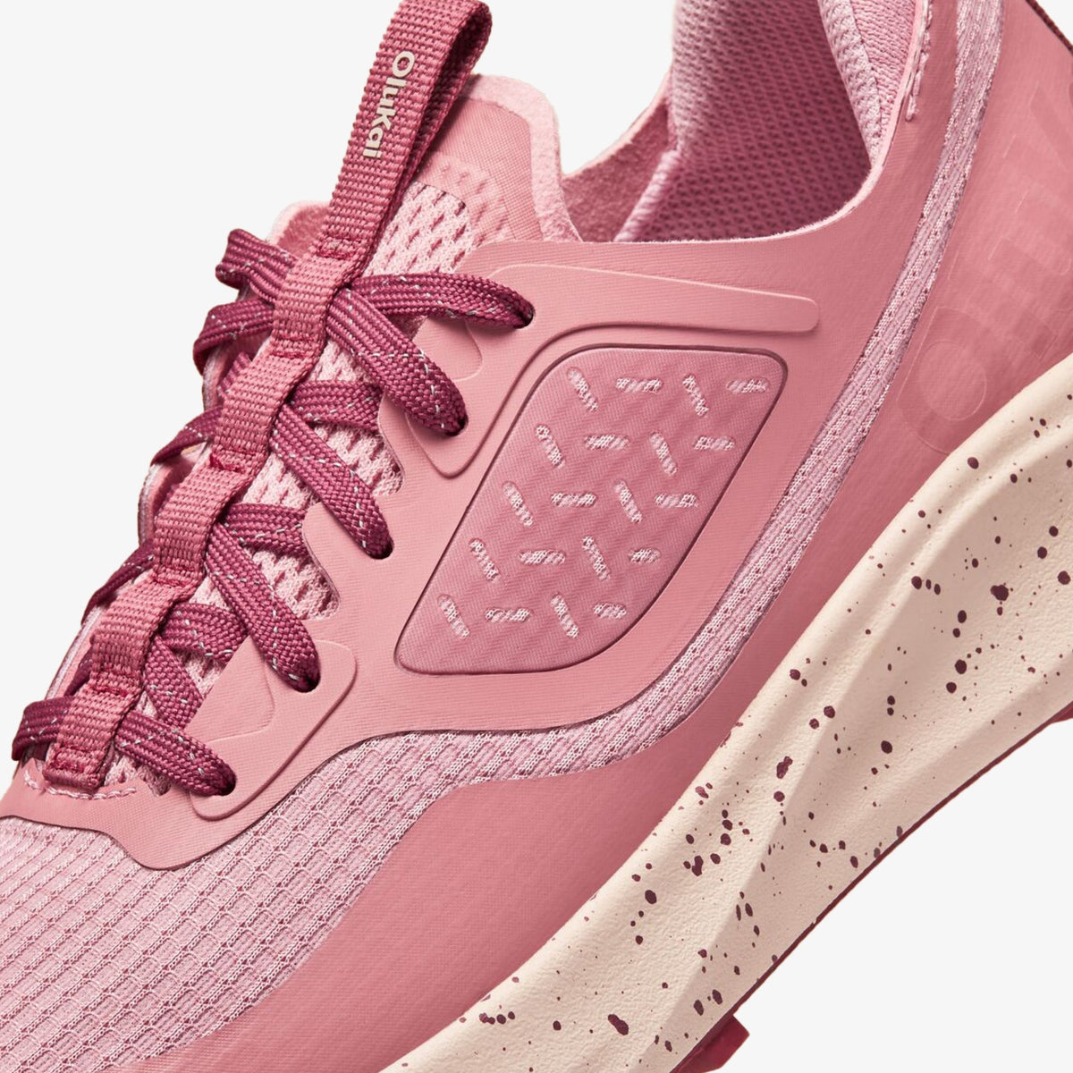 Coral rose athletic shoe with mesh and rubber panels, lace-up closure, and speckled cream sole detail.