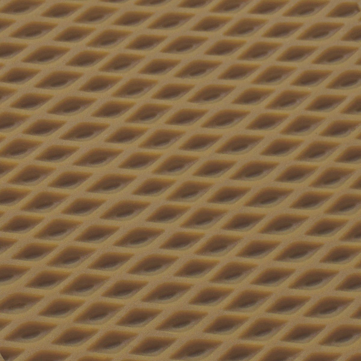 Close-up of textured tan material with diagonal diamond pattern indentations.