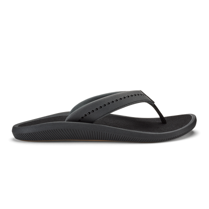 Black thong sandal with ribbed sole and studded upper strap.