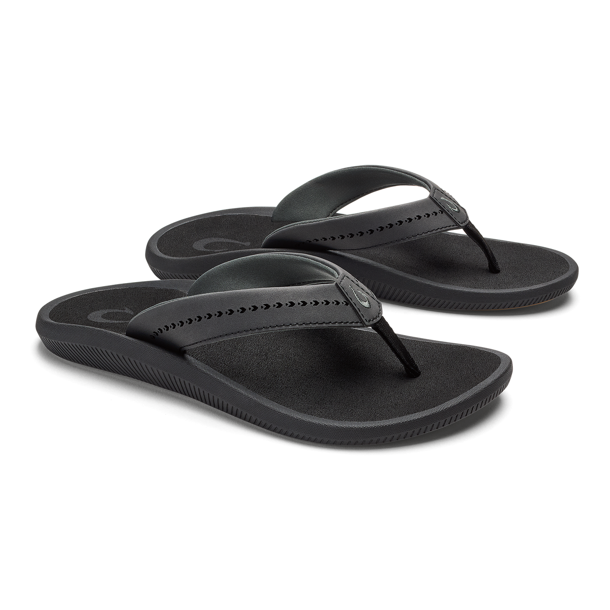 Pair of black flip-flop sandals with studded thong straps and textured footbeds.
