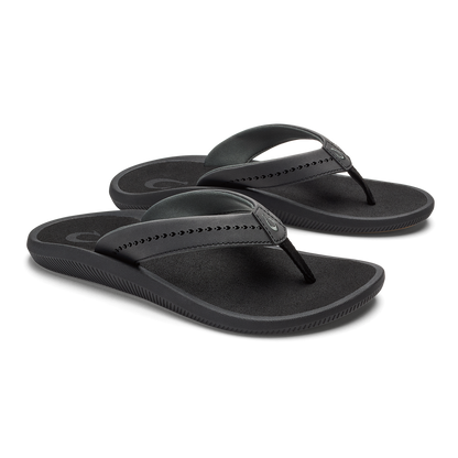 Pair of black flip-flop sandals with studded thong straps and textured footbeds.
