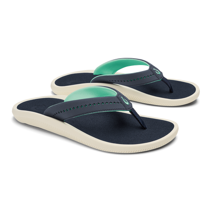 Pair of navy and mint green flip-flops with cream-colored soles and beaded thong straps.