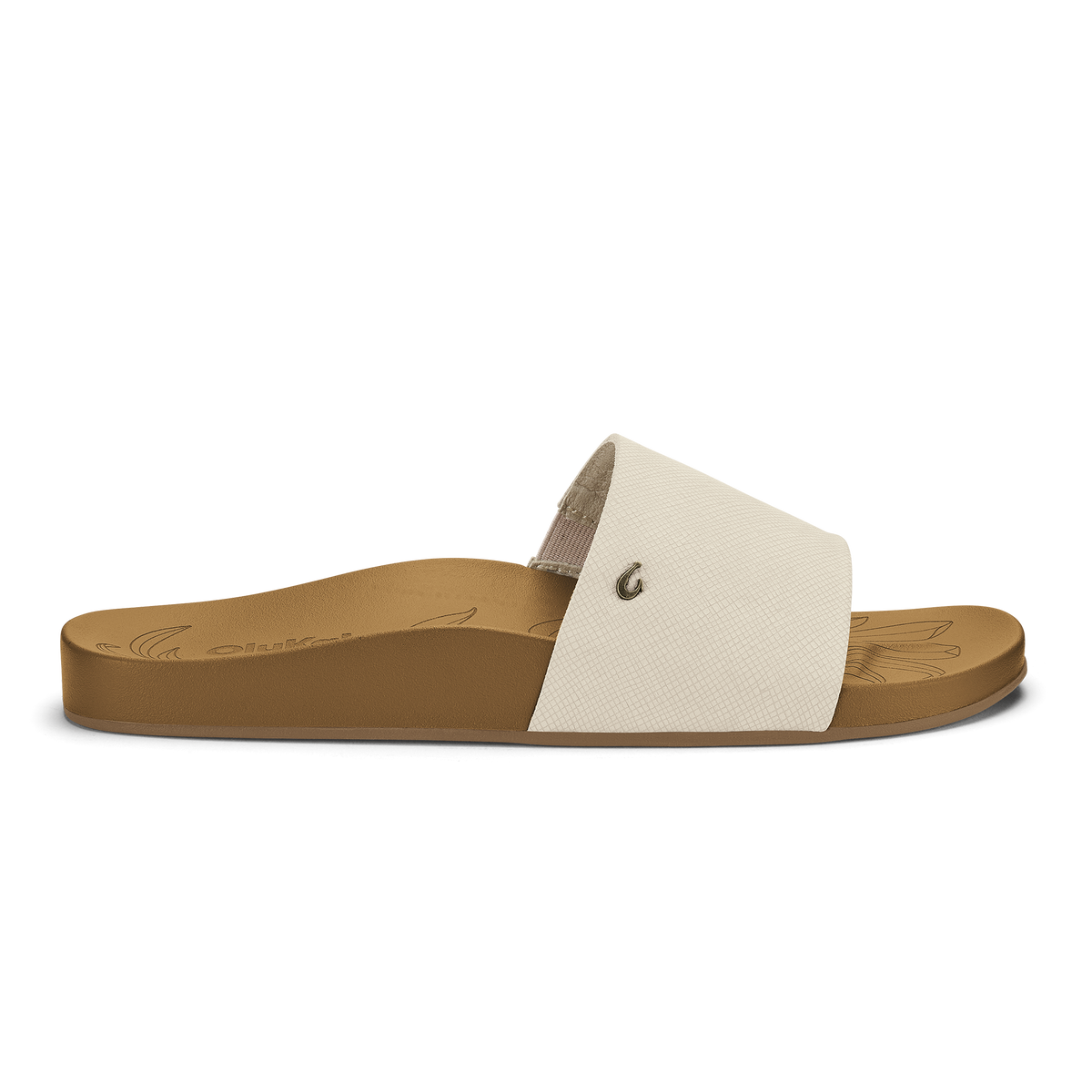 Tan slide sandal with cream textured upper strap and small metal rivet detail.
