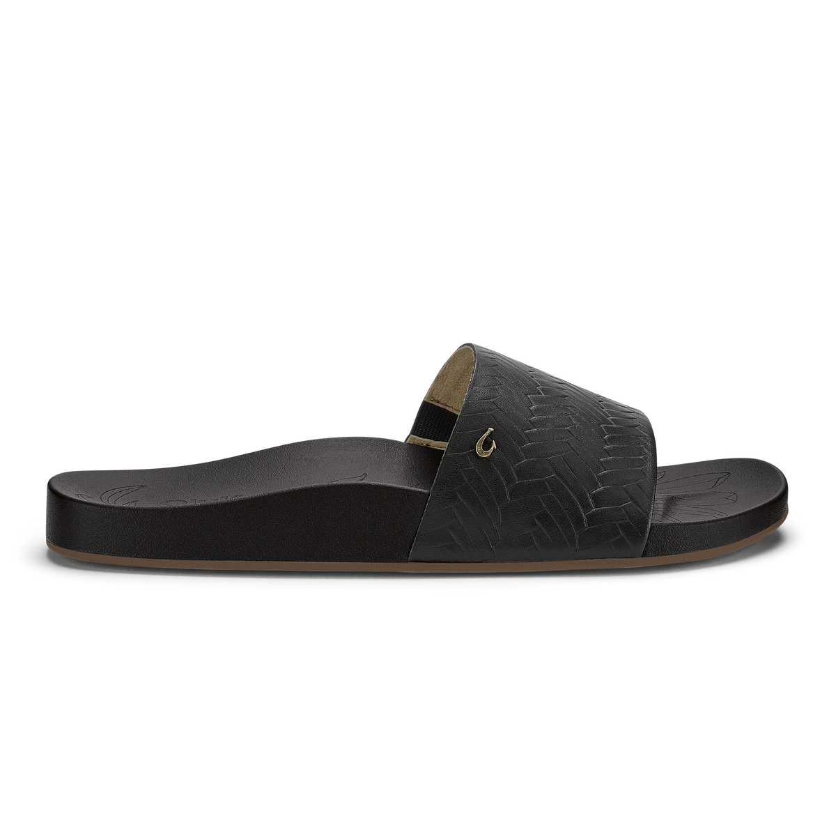 Black slide sandal with woven texture upper, tan footbed, and metallic accent buckle.