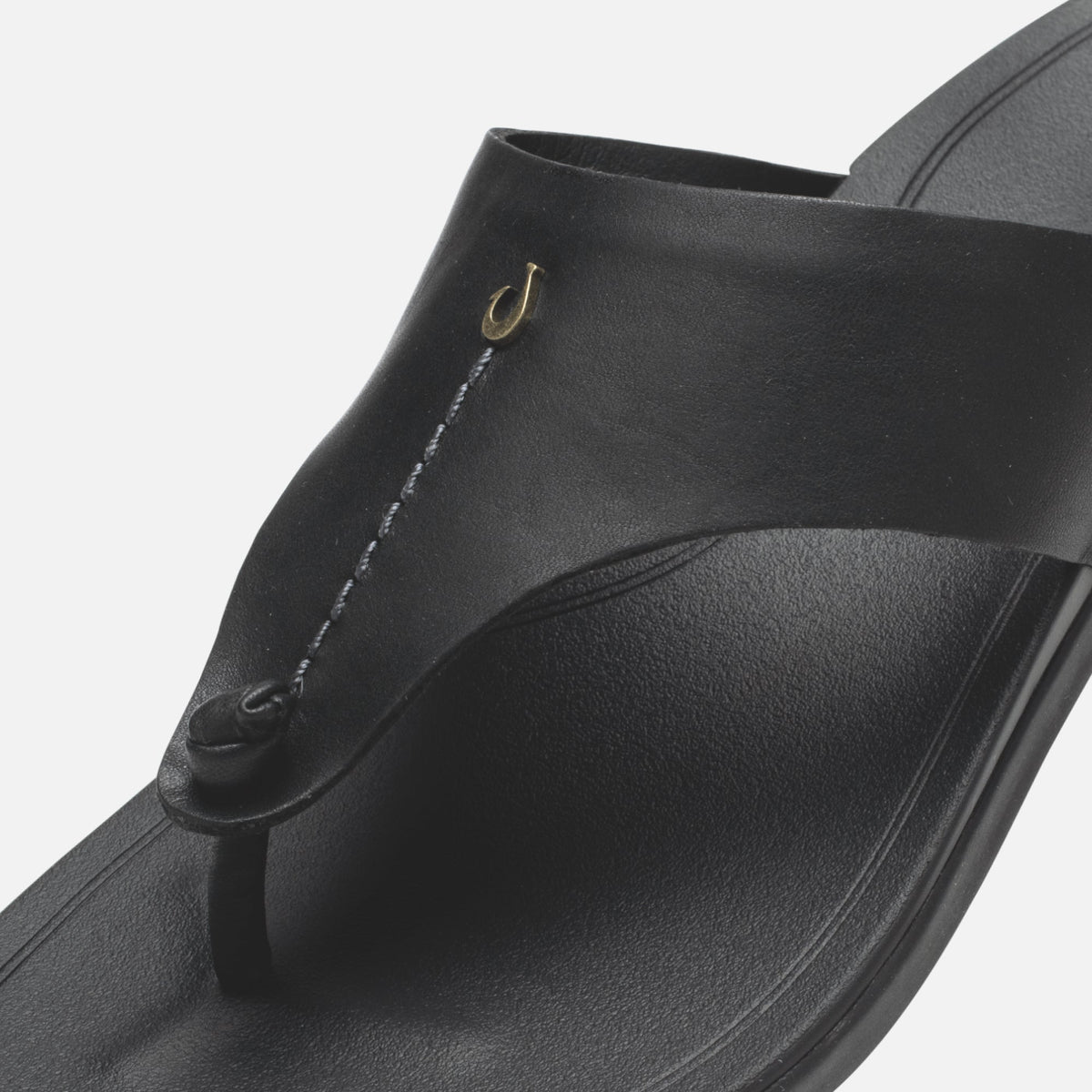 Black flip-flop sandal with gold hook detail and textured thong strap.