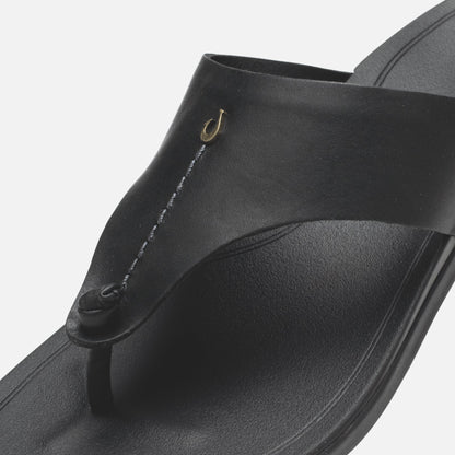 Black flip-flop sandal with gold hook detail and textured thong strap.