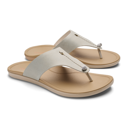 Pair of cream and tan thong sandals with padded fabric straps and cushioned soles.