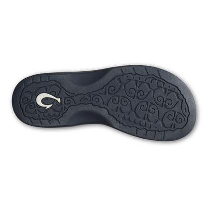 Black rubber sole with ornamental scrollwork pattern and white logo detail.