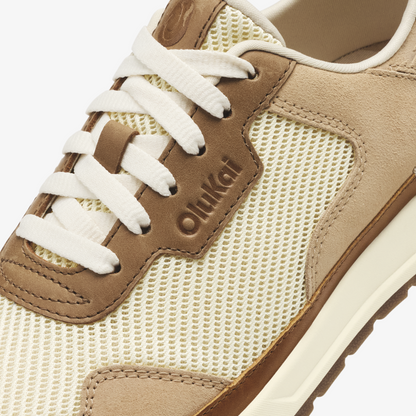 Tan and cream sneaker with mesh panels, suede overlays, white laces, and "Oulkad" branding on the side.