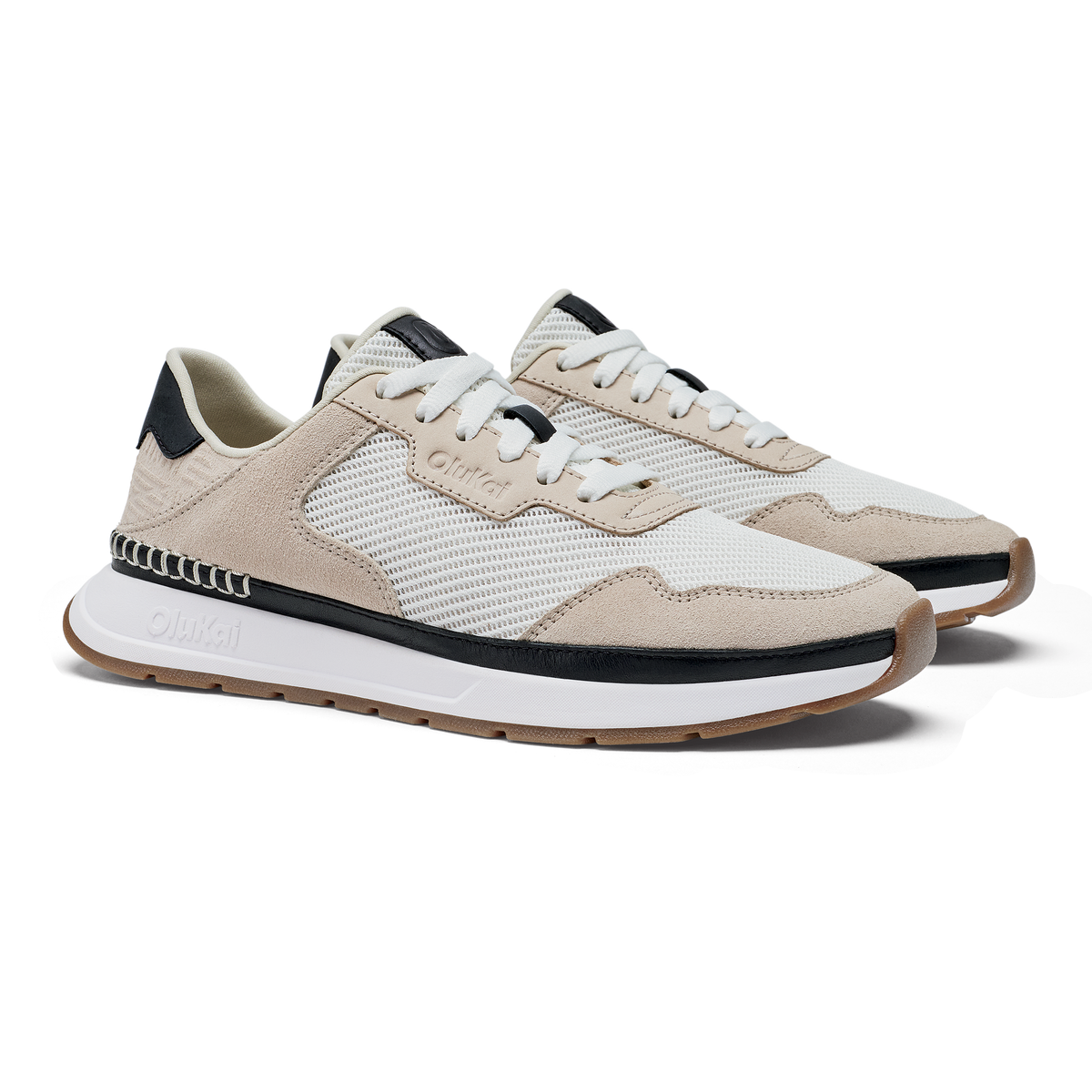 Pair of white and ecru sneakers with black heel accents and white sole.