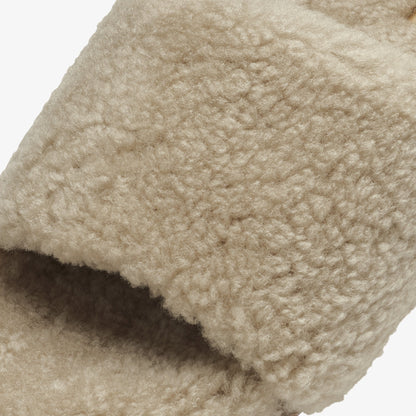 Tan wool textile with textured, chunky knit surface and folded edge detail.