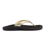 Gold metallic thong strap sandal with black cushioned sole and curved footbed.