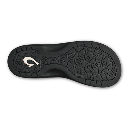 Black rubber sole with decorative scrollwork pattern and white curved logo detail.