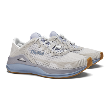White and light blue running shoe with tan heel accent and blue branding on the side.