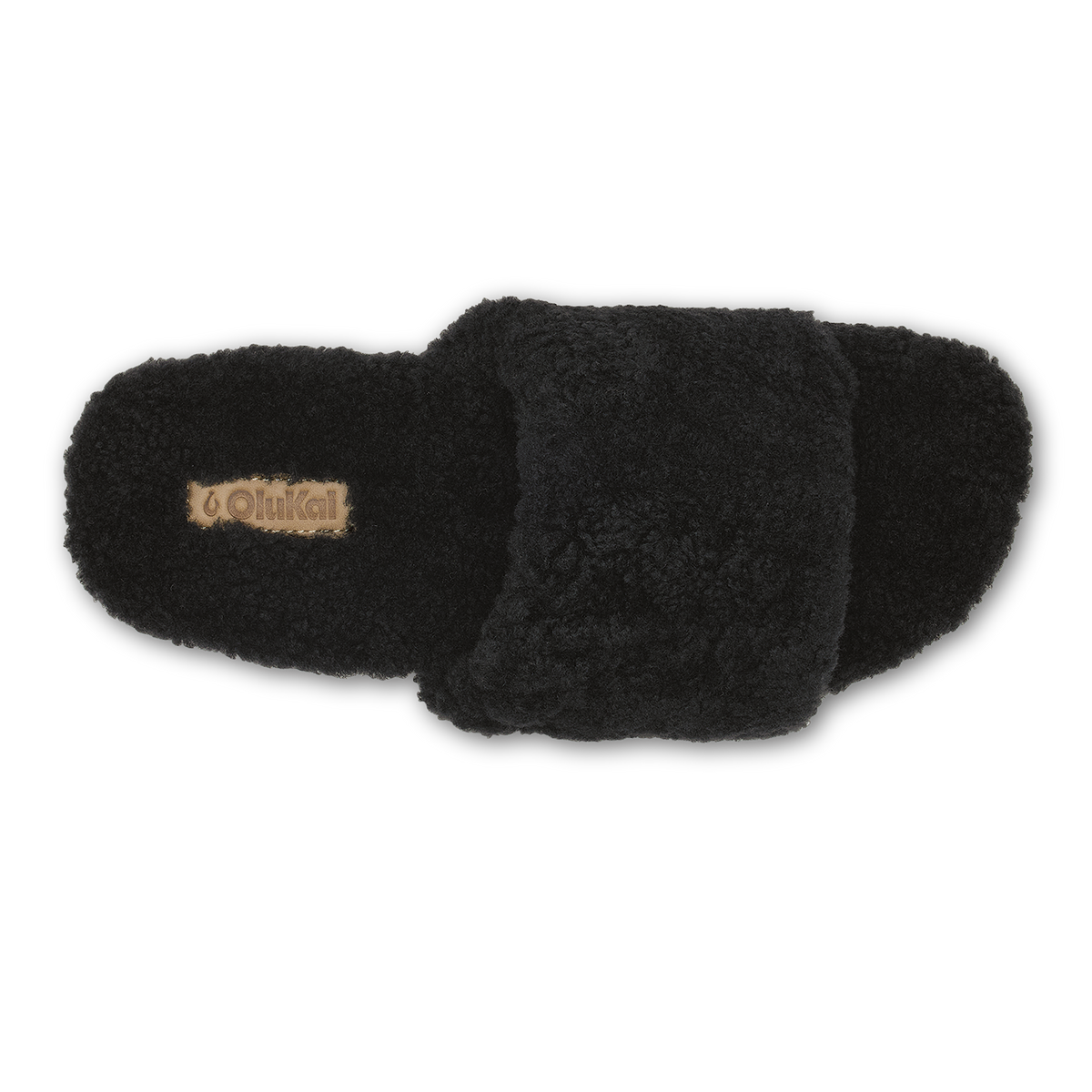 Black fuzzy slippers with tan brand label on left slipper, shown from above.
